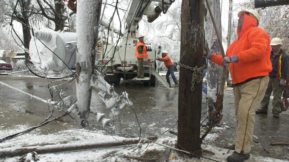 In this 2003 file photo, a crew worked to repair a broken utility pole in Lexington.