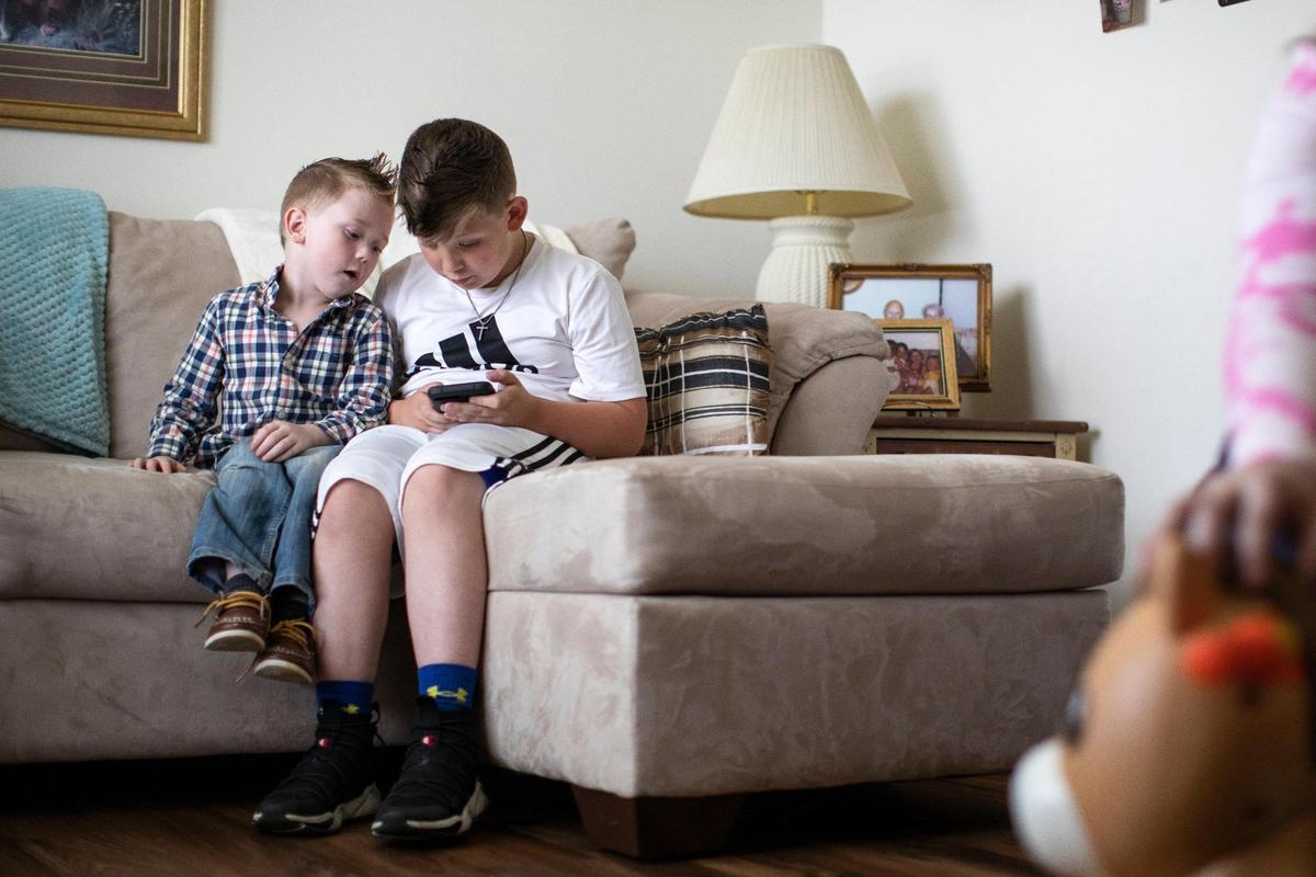 Megan’s oldest son, Charlie, watches his cousin Karson in Barbourville, Ky., Friday, May 7, 2021.