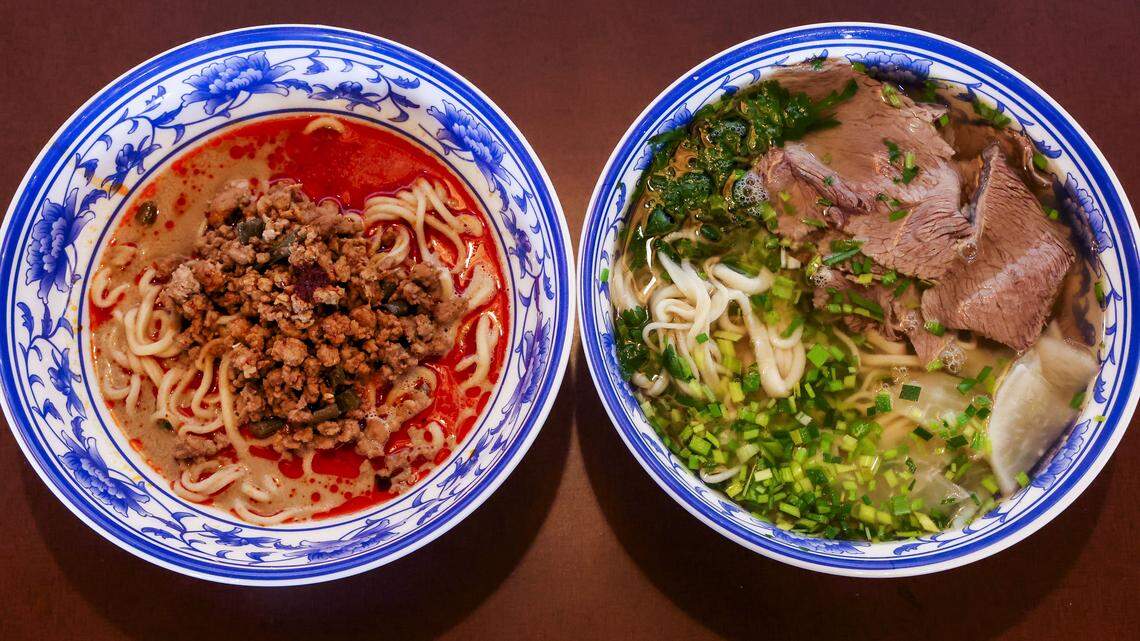 Two hand-pulled noodle dishes from Kung Fu Noodle, photographed Wednesday, Aug. 13, 2025, in Lexington, Ky. At left is Dan Dan Hand-Stretched Noodles with ground pork, long string beans, sesame paste and special garlic sauce ($12.95). At right is Lanzhou Beef-Noodle Soup which is served with braised beef slices, sliced white radish, green garlic, cilantro in a dark beef broth ($12.95). Owner Dennis Zhang said the classic Chinese dish is known for its homemade noodles, particularly the texture and the broth. “It's the soul of that dish.”