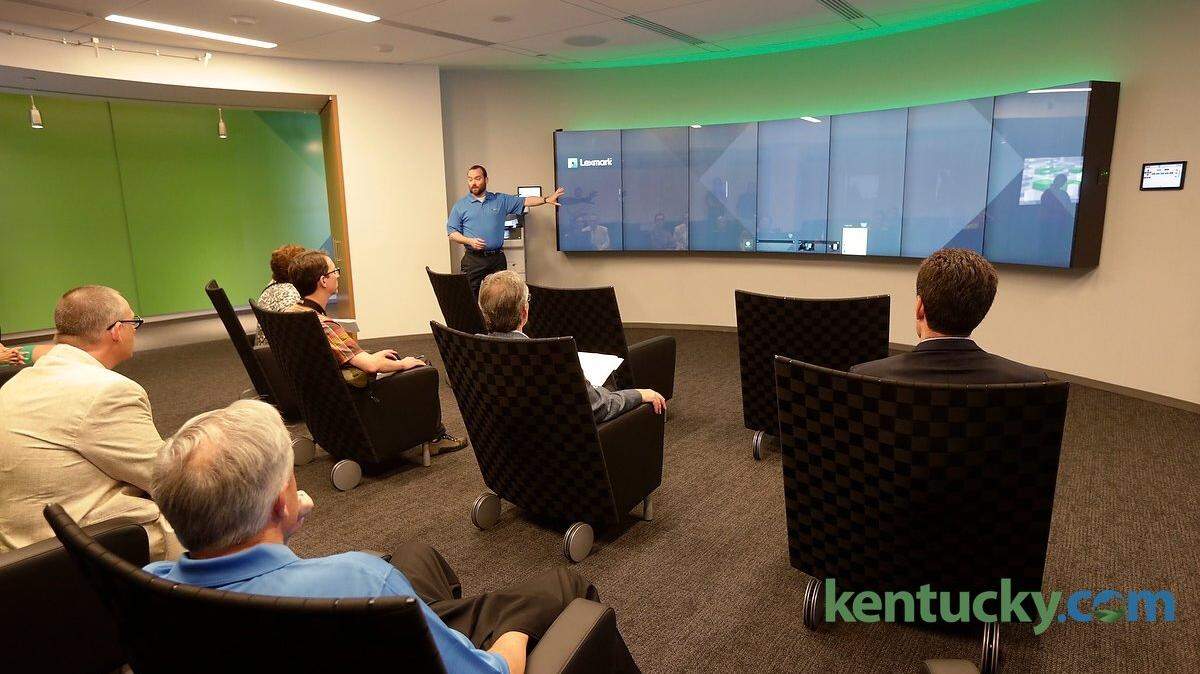 Jason Bright, a global industry manager, gave a presentation using a display board featuring seven touchscreen monitors in the new customer experience center at Lexmark.