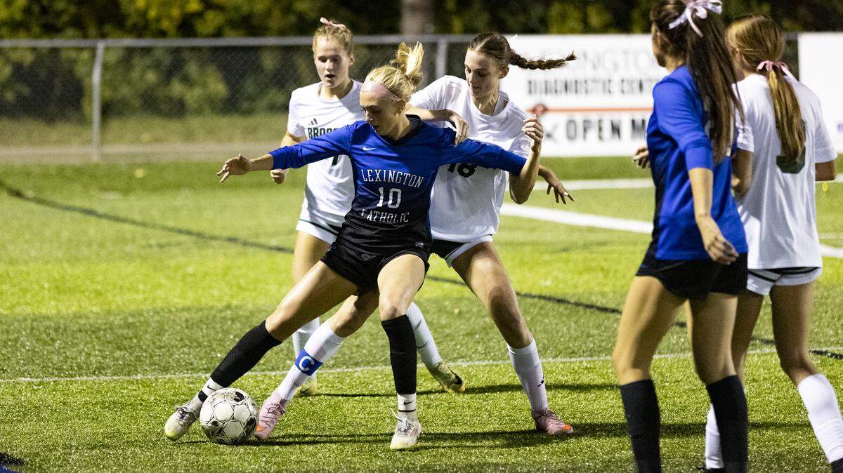 Lexington Catholic’s Joanna Bryant (10) fended off Bishop Brossart’s Mackenzie Moeller, left, and Rachel Shewmaker during the first half of the Knights’ 4-3 win in the first round of the KHSAA Girls State Soccer Tournament on Tuesday.