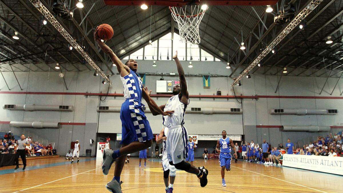 Aaron Harrison prepared to throw down a dunk during the first half of Kentucky's 81-58 win over Champagne Chalon-Reims during the Wildcats' exhibition tour in the Bahamas this past August.    