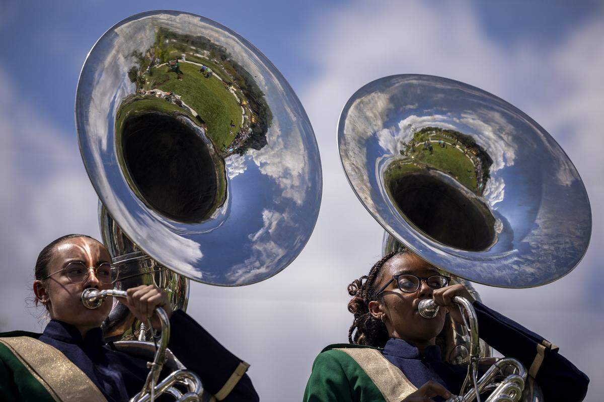 Max, left, and Naziah, members of the Bryan Station marching band, play the Sousaphone during the opening of Gatton Park on Saturday, Aug. 23, 2025, in Lexington, Ky. 