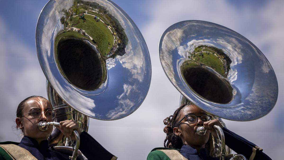 Max, left, and Naziah, members of the Bryan Station High School marching band, play the sousaphone during the opening of Gatton Park on Saturday, Aug. 23, 2025, in Lexington, Ky.