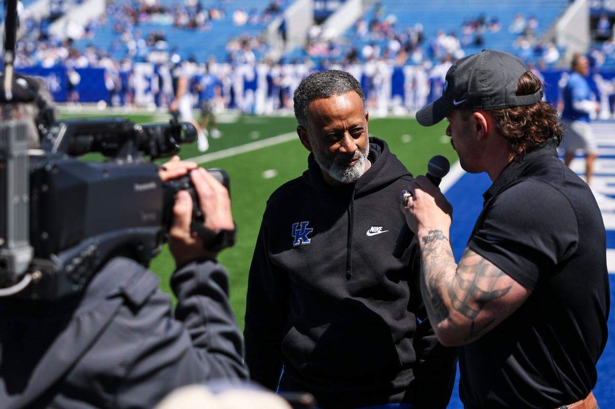 Kenny Brooks, center, was the head coach at James Madison and Virginia Tech before taking the job at Kentucky earlier this year.