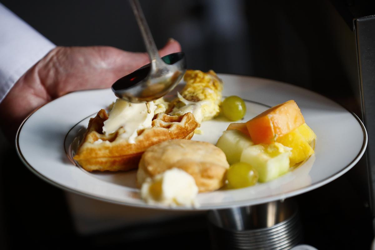 Keith Benze, of Versailles, Ky., fills his plate from the brunch buffet at Spark Community Cafe in Versailles, Ky., Sunday, June 23, 2019. Spark Community Cafe operates on a pay what you can scale and offers people an opportunity to volunteer time in exchange for their meal.