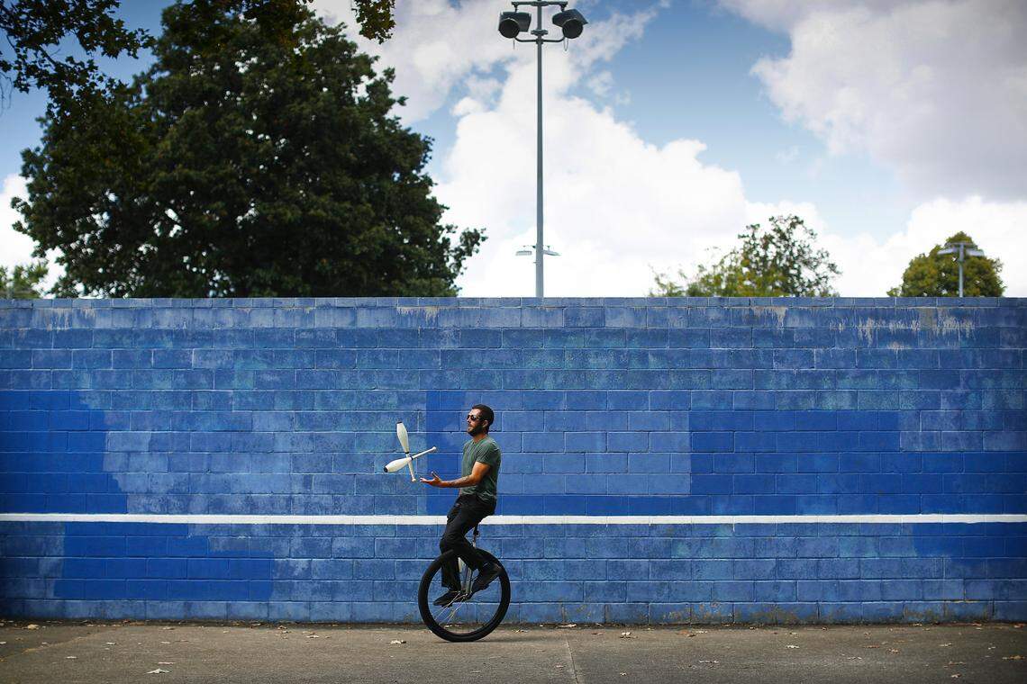 Jeremy McKinley, of Lexington, Ky., juggles clubs on a unicycle at Woodland Park in Lexington, Monday, Sept. 2, 2019. McKinley picked up juggling as a hobby about three years ago and took advantage of the Labor Day holiday to practice at the park.