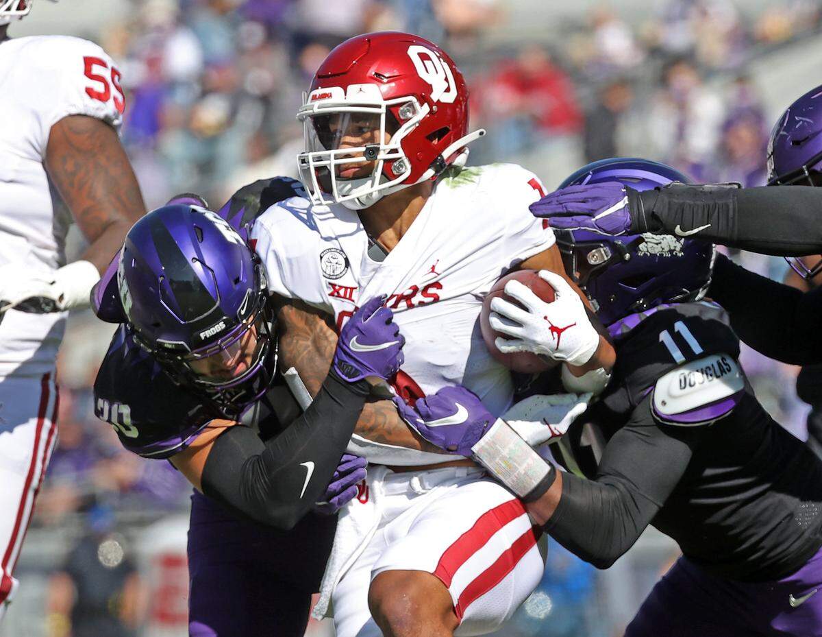 Oct 24, 2020; Fort Worth, Texas, USA; TCU Horned Frogs defensive end Khari Coleman (11) tackles Oklahoma Sooners running back Seth McGowan (1) during the first half at Amon G. Carter Stadium. Mandatory Credit: Kevin Jairaj-USA TODAY Sports
