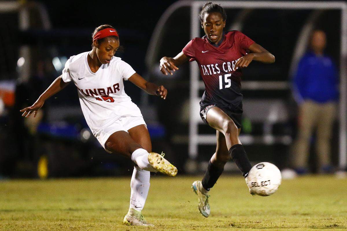 Paul Laurence Dunbar’s Meron Roach (15) cleared the ball away from Tates Creek’s Alex Smith (15) during their 43rd District semifinal last year. Both players will be a big part of each team again this season.