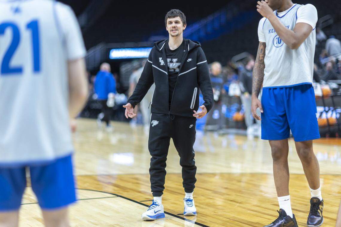 Kentucky Wildcats guard Kerr Kriisa (77) talks with his teammates at Fiserv Forum in Milwaukee, Wis., on Thursday, March 20, 2025, ahead of Kentucky’s first NCAA Tournament game against Troy.