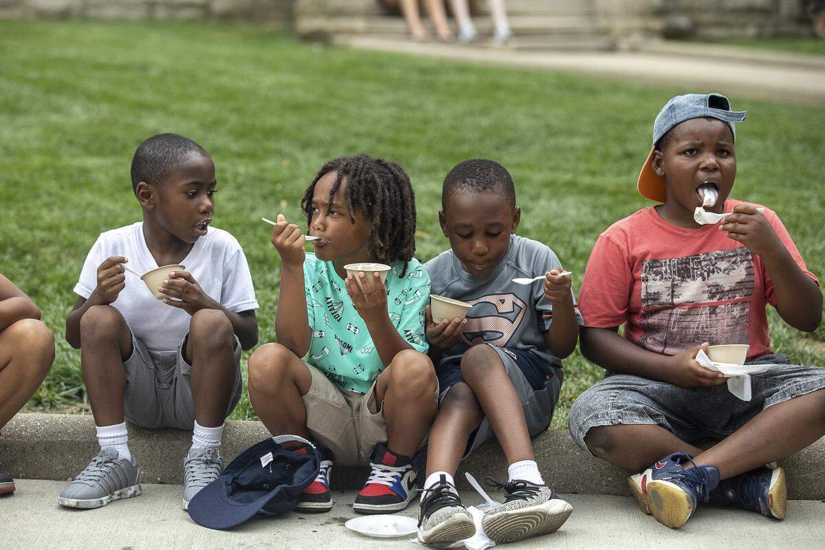 Christian Mack, from left, 7, Israel Joffrin, 7, Tahj Gardner, 5, and Tyree Johnson, 9, eat pie and ice cream at the Great American Pie Contest and Ice Cream Social at Fifth Third Bank Pavilion in Lexington, Ky., Wednesday, July 3, 2019.