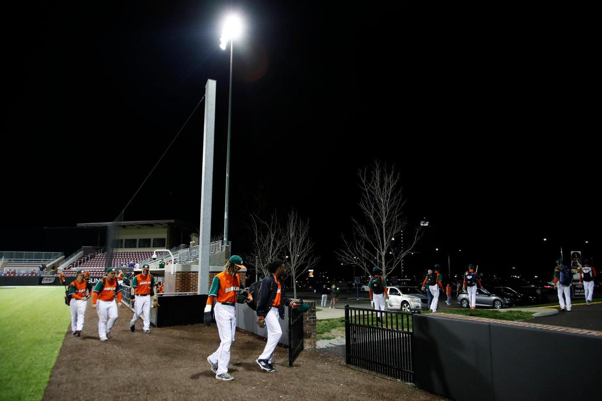 Frederick Douglass players leave the field after officials decided to suspend their game against Henry Clay with a severe storm threatening at Eastern Kentucky University’s Earle Combs Stadium in Richmond on Wednesday night.