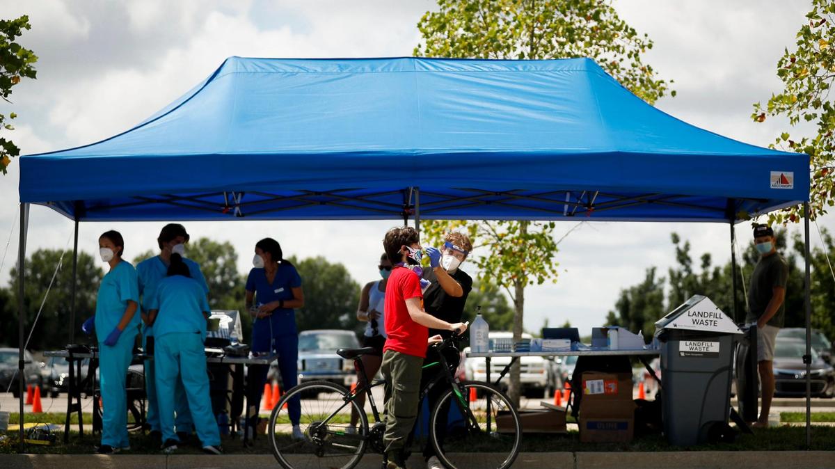 Conner Sheetz, of Lexington, Ky., a sophomore environmental science and sustainability major, left, is tested for COVID-19 by Ryan Bertram, of Louisville, Ky., a COVID specialist with Wild Health at Kroger Field in Lexington, Ky., Tuesday, Aug. 4, 2020. Testing will be available for all students between 8 a.m. and 4 p.m. through Aug. 22.