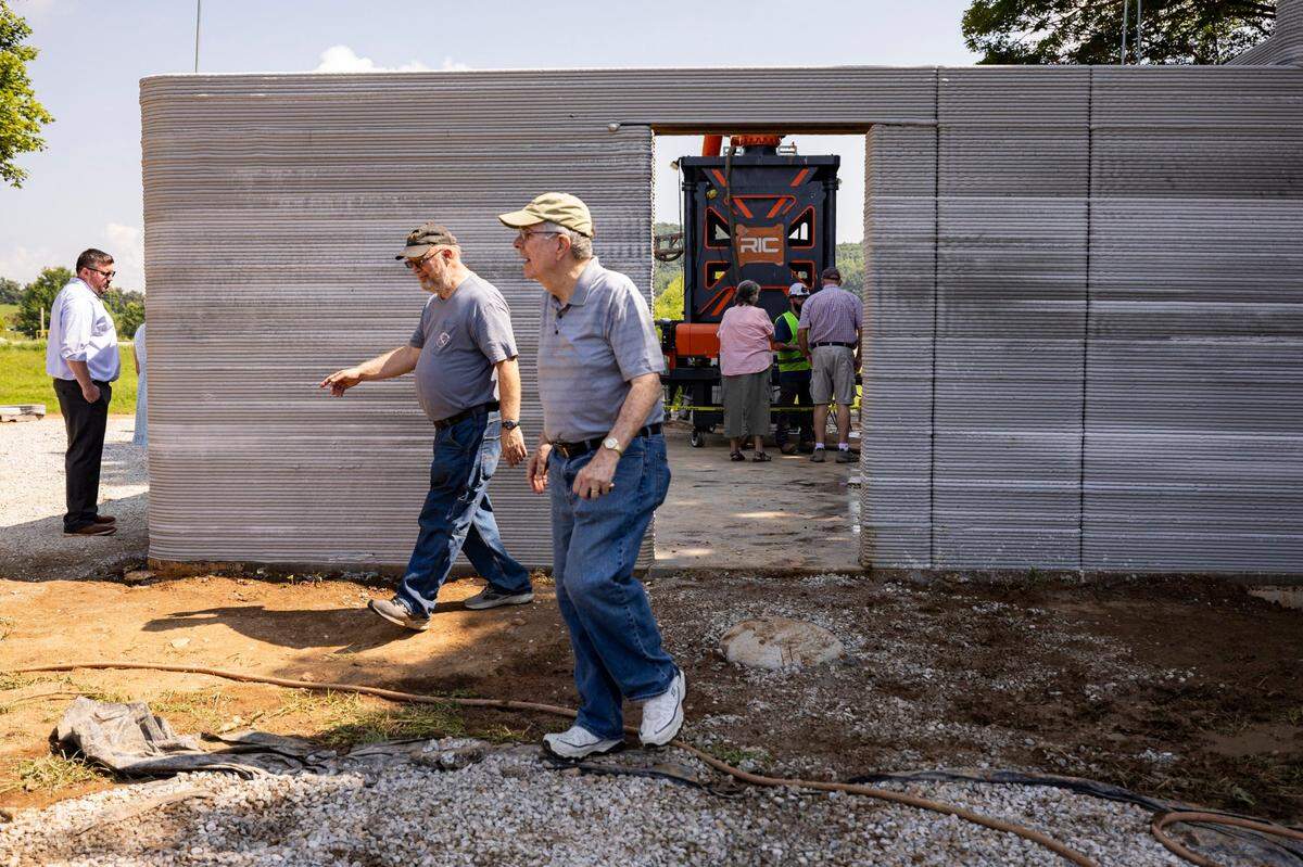 Ted Noe, left center, and Bill Reed, right center, members of the Woodford County Habitat board, walk out of Floodbuster 1 on Friday, June 27, 2025, at the Somerset Community College Valley Oak Center in Somerset, Ky.