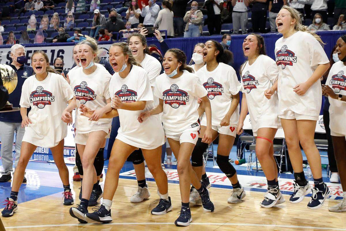 Sacred Heart players enjoyed the trophy presentation ceremony after winning the school’s fifth state title.