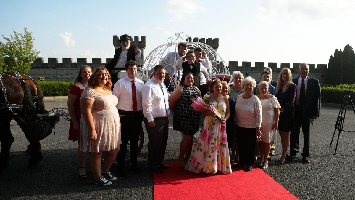 Michele, 17-year-old girl from Winchester with a nervous system disorder, poses with family and friends for a portrait outside of the Kentucky Castle in Versailles before attending a princess-themed ball hosted for her by Make a Wish, August 12, 2021.