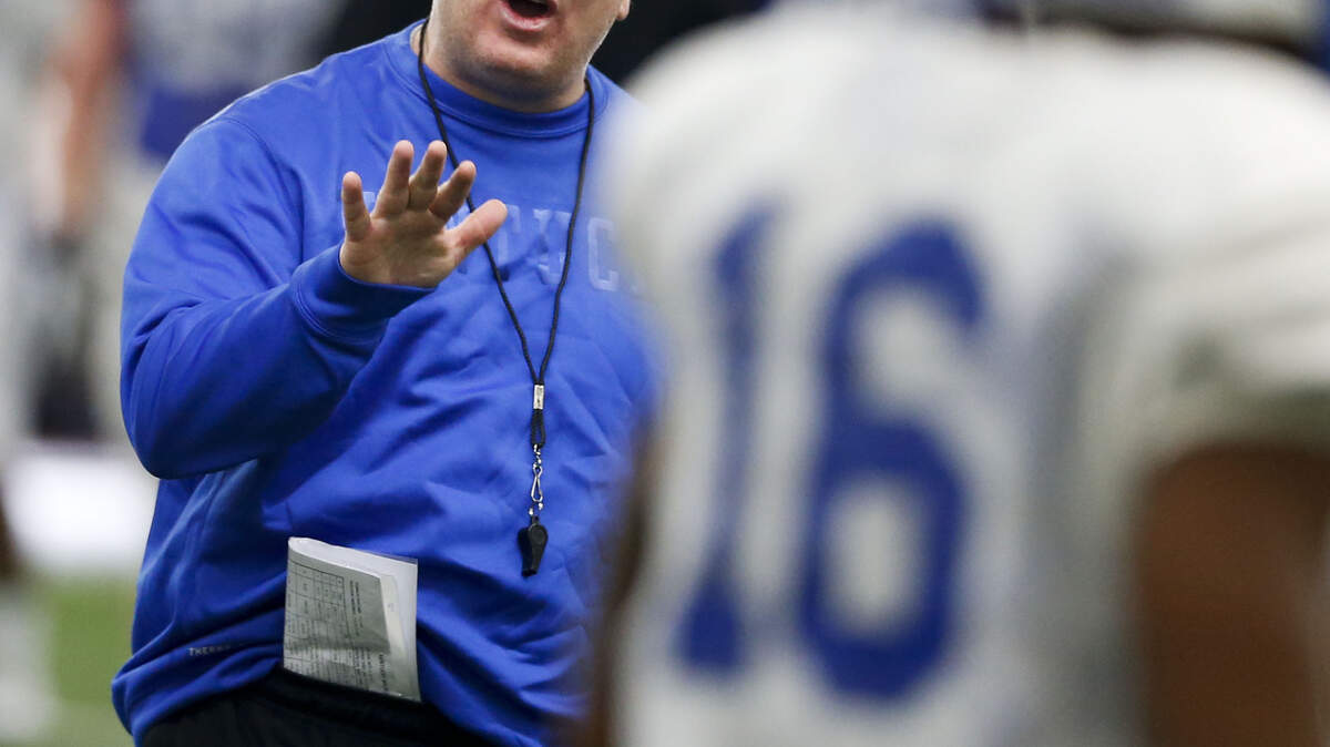 Kentucky head football coach Mark Stoops delivered instructions during practice Wednesday inside the Nutter Field House. "We're just trying to show them they don't understand the sense of urgency that it takes to win at a high level," he said later.        