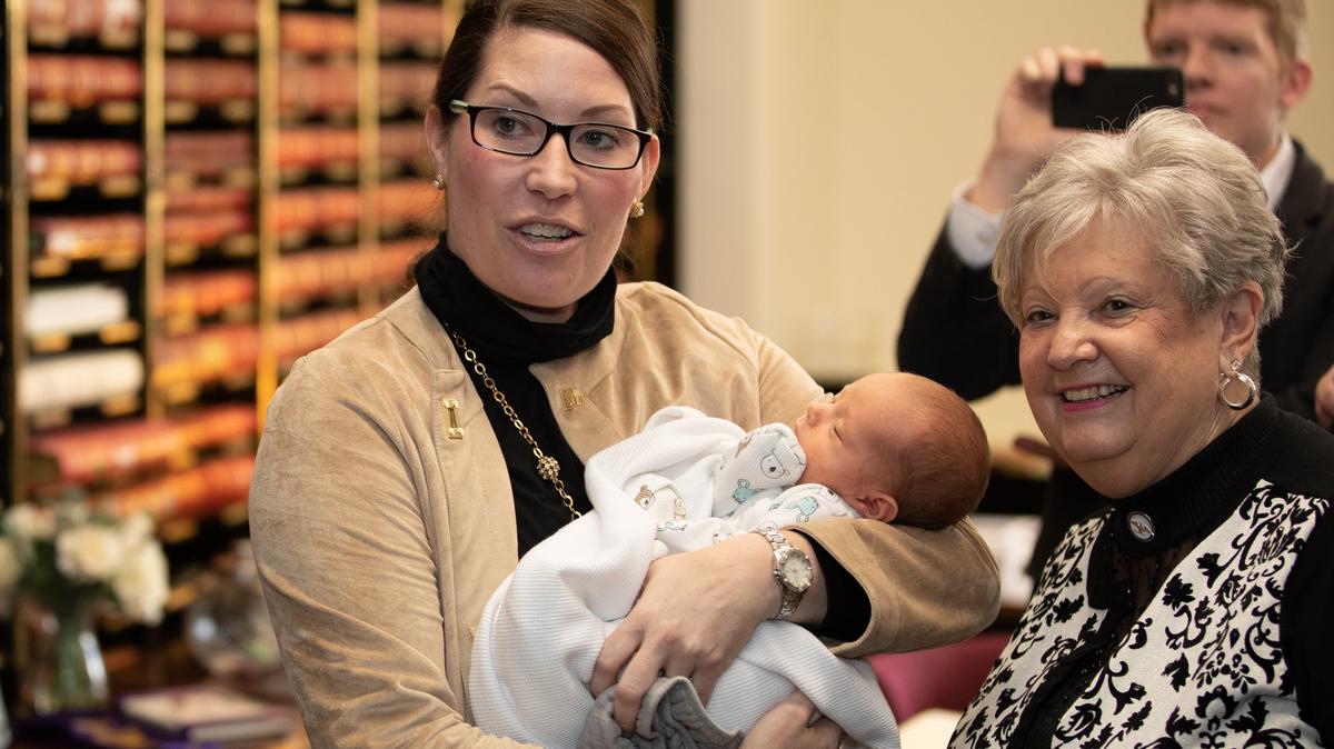 Secretary of State Alison Lundergan Grimes shuts her office door at 4 p.m filing deadline on Tuesday Jan. 29, 2019 with her four-week-old son Ford Grimes in Frankfort, Ky. and Mary Sue Helm, a state elections official.