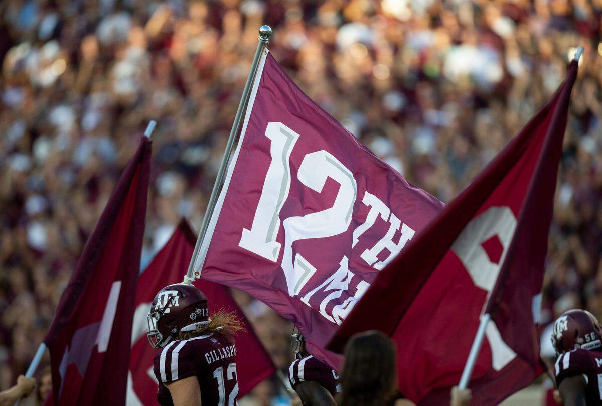 Texas A&M fullback Cullen Gillaspia (12) carried the 12th Man flag as the Aggies took the field before playing ULM at Kyle Field on Sept. 15.
