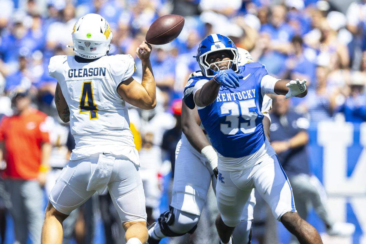 Kentucky linebacker Steven Soles Jr. (35) deflects a pass by Toledo quarterback Tucker Gleason (4) during Saturday’s game at Kroger Field.