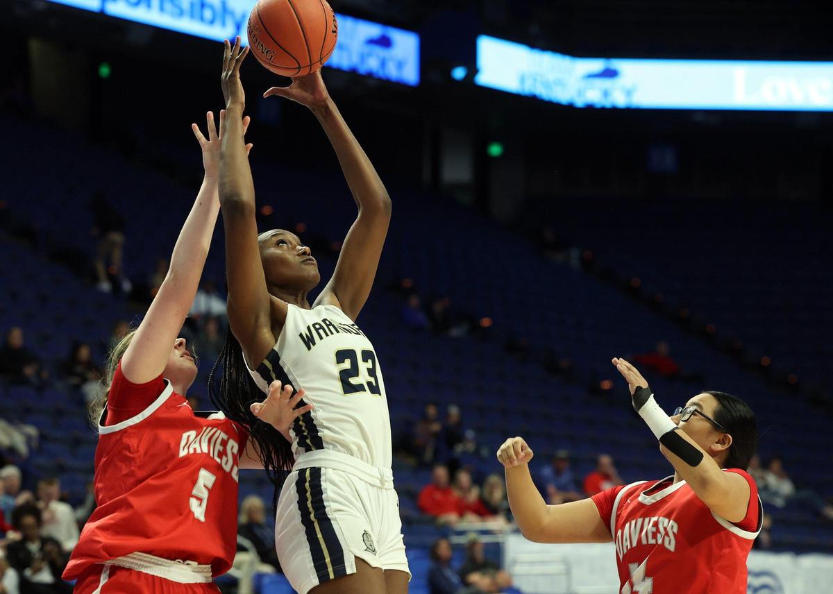 Danville Christian’s Grace Mbugua (23) pulls in a pass between Daviess County defenders during a first-round game in the Girls’ Basketball Sweet 16 at Rupp Arena on Thursday.