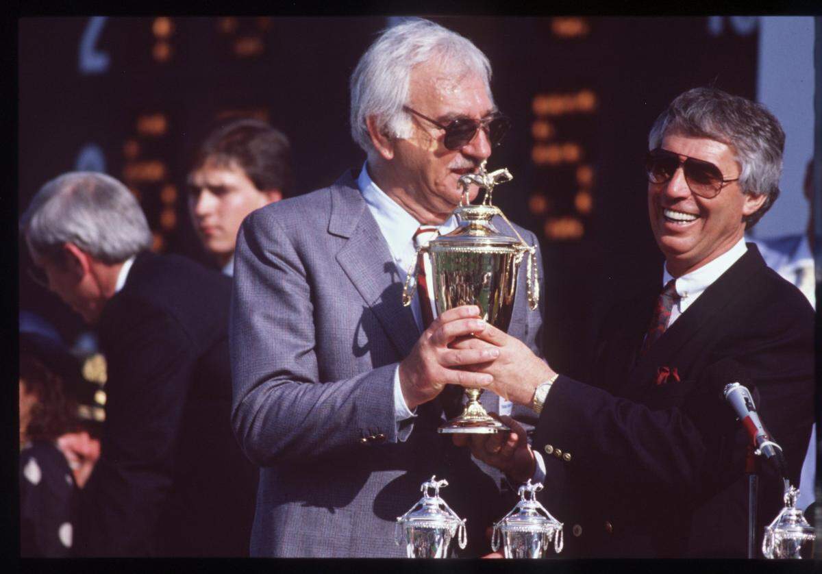 Trainer D. Wayne Lukas, right, held the 1988 Kentucky Derby winner’s trophy with Eugene Klein, owner of the champion filly Winning Colors.