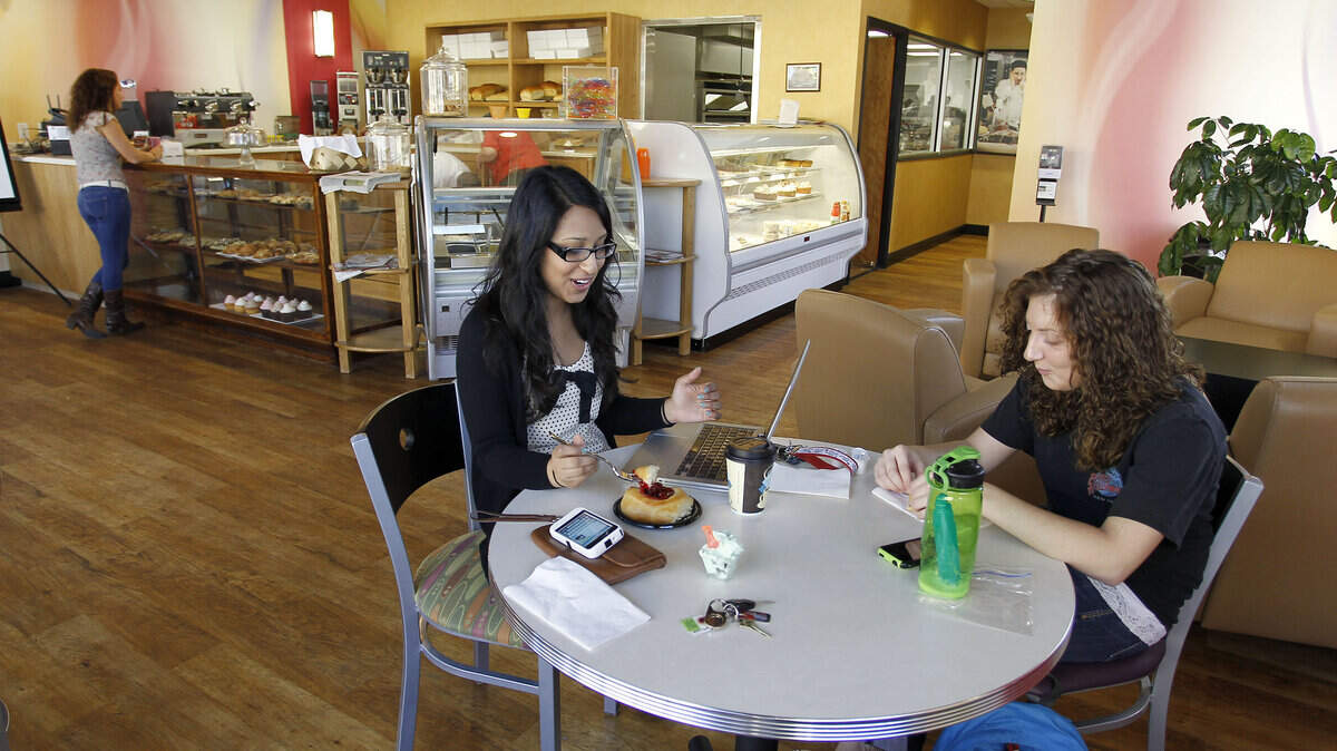 Customers Sofeia Aslam and Tiffany Stacy, enjoyed dessert while Mary Dameron, in background, ordered hers, at The Bakery On Main, 178 East Main St. in Morehead, Ky., Thursday, October, 6, 2011. All of the breads, desserts,  gelato and sorbet are made in house.Charles Bertram | Staff