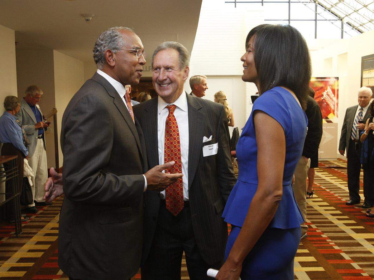 Adrian Smith, center, a 2006 inductee into the University of Kentucky Athletics Hall of Fame, spoke with former UK men’s basketball coach Tubby Smith, left, and ex-Kentucky women’s basketball star Leslie Nichols-Carter, right, during a reception prior to the 2013 induction ceremony.