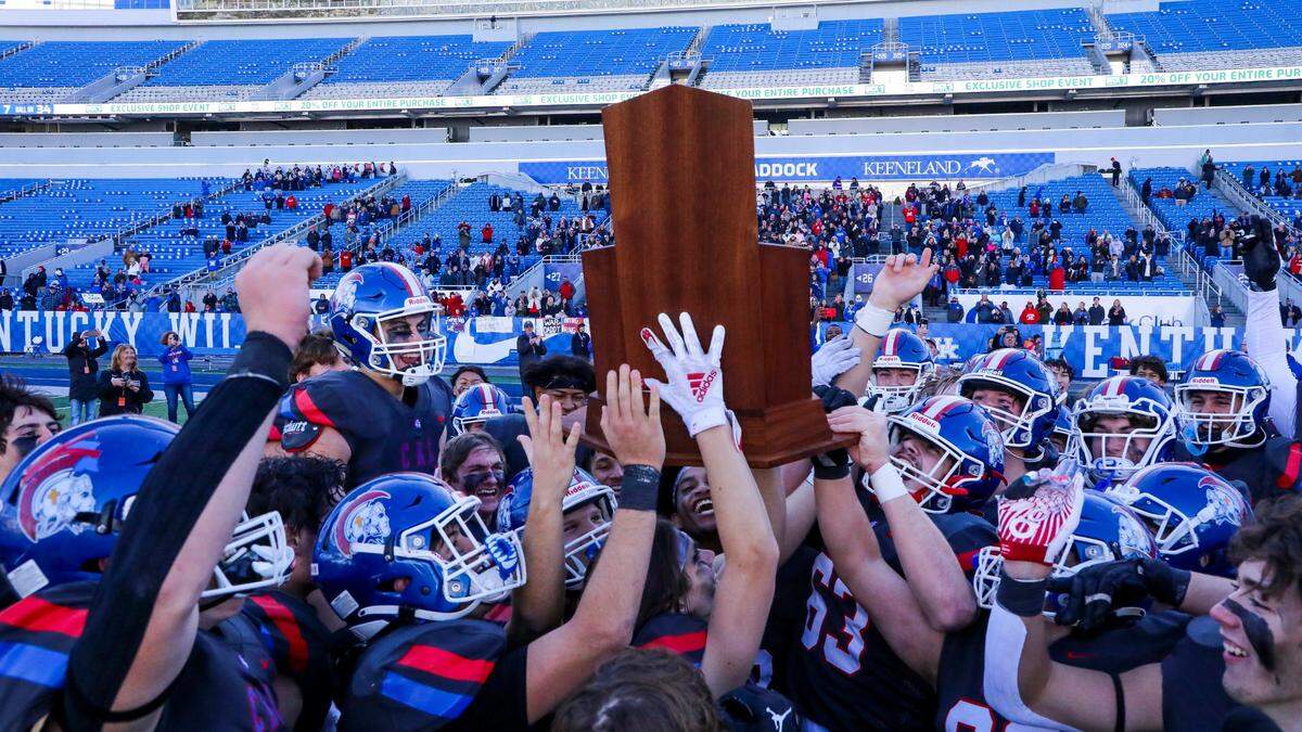 The Christian Academy-Louisville football team celebrates the school’s third state championship.