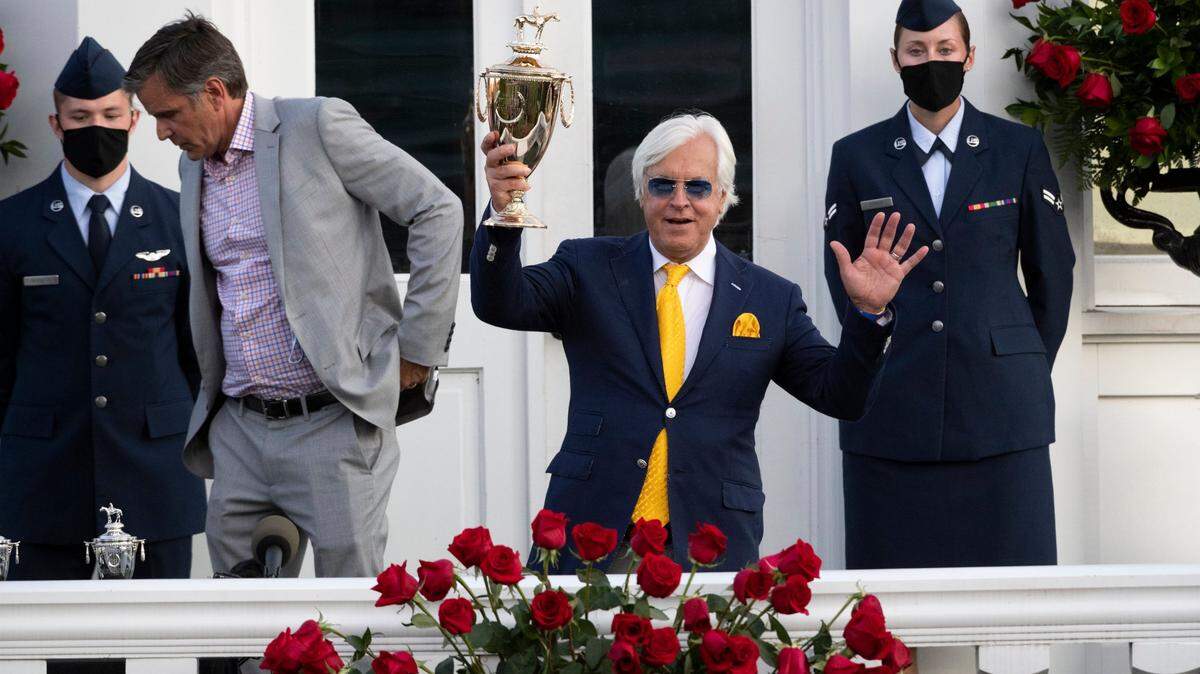 Trainer Bob Baffert holds up the winning trophy after Authentic with John Velazquez up won the 146th running of the Kentucky Derby last September at Churchill Downs.