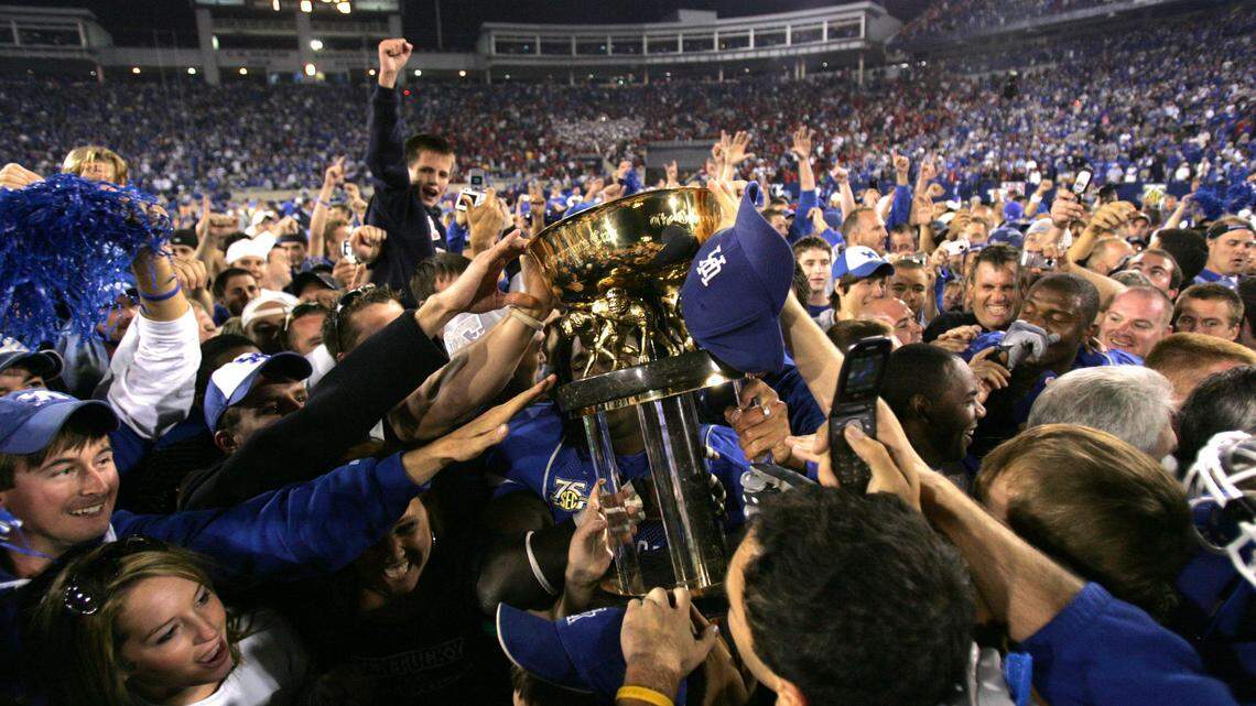 Fans and players celebrated with the Governor’s Cup trophy as the University of Kentucky beat in-state rival Louisville 40-34 at Commonwealth Stadium in 2007. It was Rich Brooks’ first win over U of L. The Cardinals haven’t beaten the Wildcats since.      