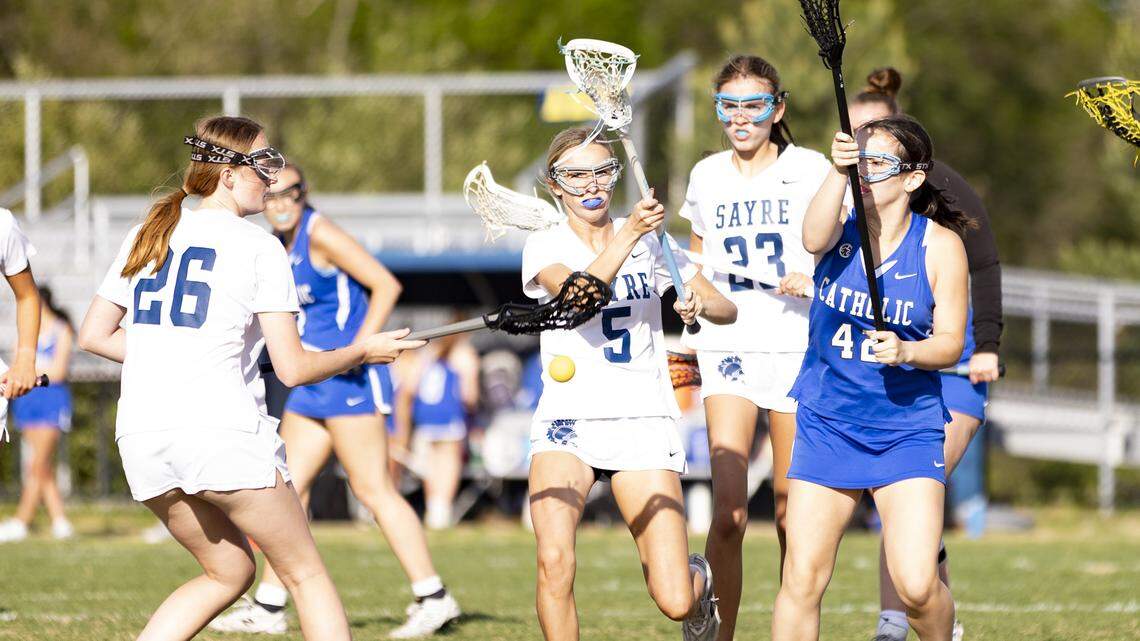Sayre’s Margaret Neely (5) tries to regain possession of the ball between teammate Kathryn Kinder (26) and Lexington Catholic’s Olivia Mattingly (42) during the Spartans’ 10-5 win over Lexington Catholic as the Sayre Athletic Complex on Thursday.