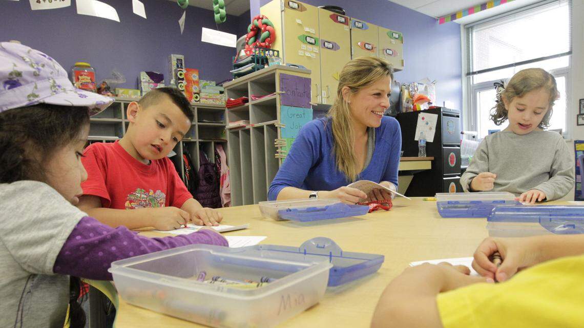 Teacher Alicia Coves, center, worked with kindergarten students in March at Cardinal Valley Elementary School in Lexington. Cardinal Valley students' school day begins at 7:45 a.m. and ends at 2:35 p.m.   
