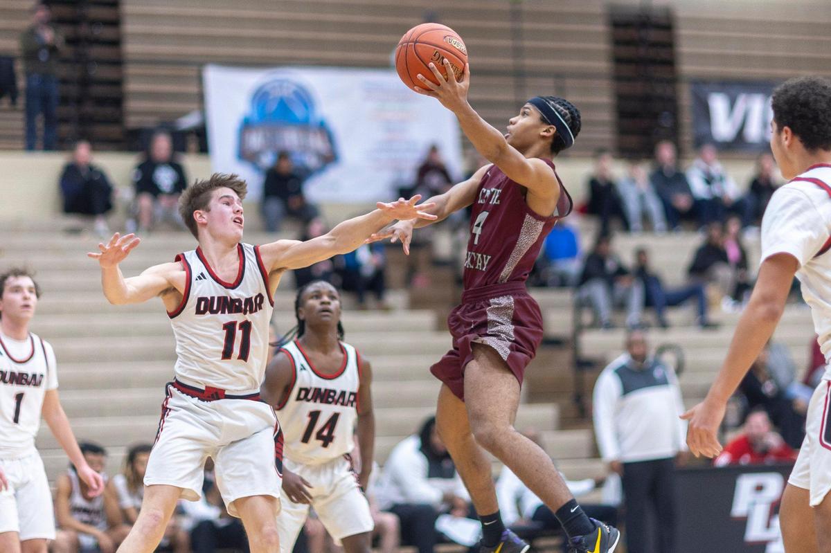 Tates Creek’s Stephen Franklin (4) shoots as Paul Laurence Dunbar’s Asher Horn (11) defends during their game at Paul Laurence Dunbar on Thursday.