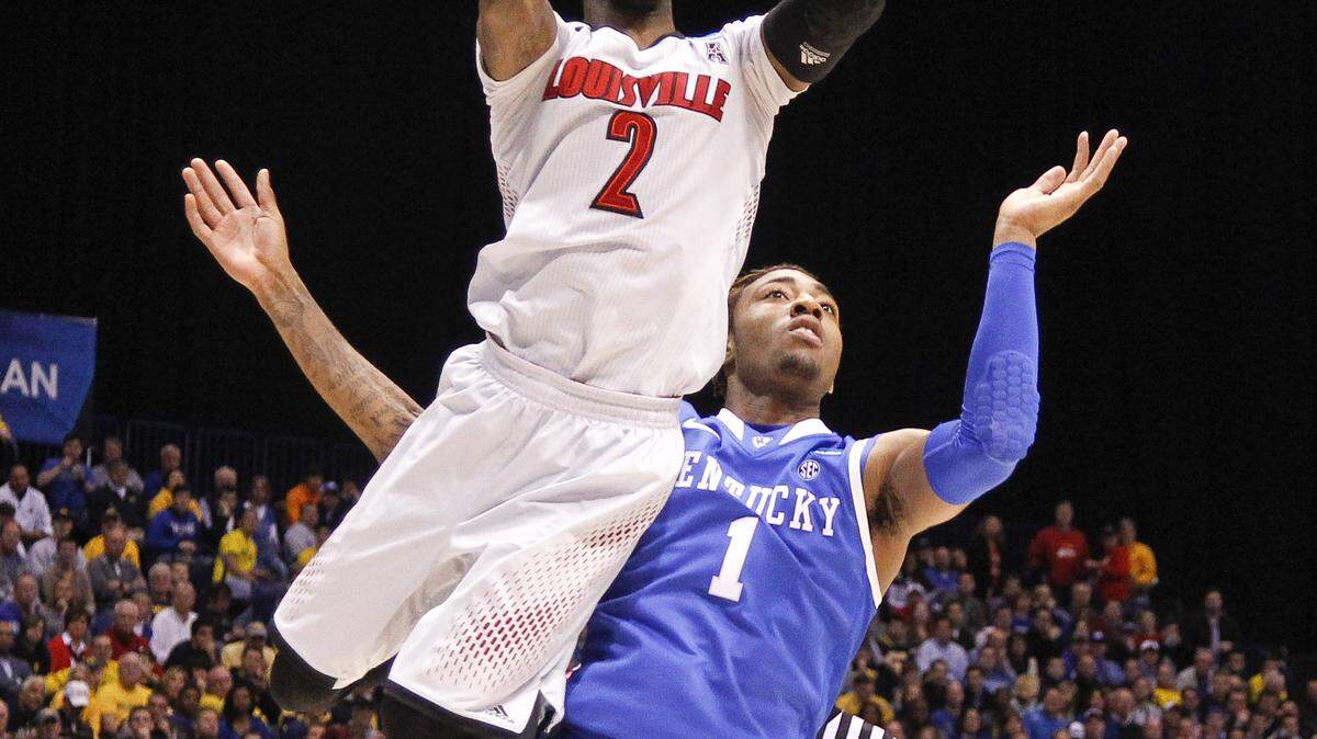 Louisville Cardinals guard Russ Smith (2) drove past Kentucky Wildcats guard/forward James Young (1) for a layup  as Kentucky played Louisville on Friday March 28, 2014 in  Indianapolis, IN. Photo by Mark Cornelison | Staff