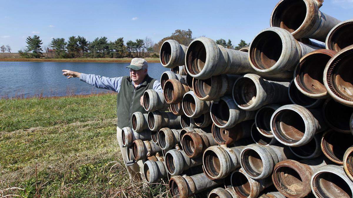 Farmer Bob Barton explained how irrigation pipes bring water from a lake on Barton Brothers Farm to its tobacco and corn crops. The lake, created in the 1940s, is one of many in Fayette County alone that were built with money from state and federal soil conservation districts.