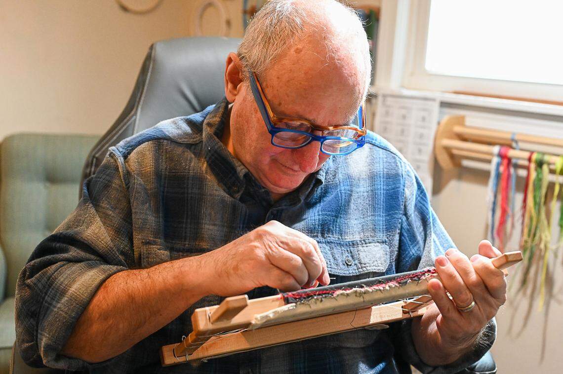 Martin Matisoff works on a piece of embroidery in the studio of his Frankfort home. He wears two pairs of glasses to better see the intricate stitching. Sharon Matisoff and Martin Matisoff are visual artists based in Frankfort, Kentucky. They will both be featured in the Kentucky Crafted Market March 9 and 10, 2024 at the Kentucky Horse Park’s Alltech Arena in Lexington, Kentucky.