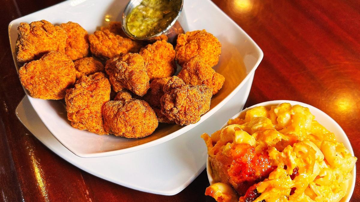 Sassy Bleu Fine Southern Dining serves comfort and soul food, such as salmon bites with a creamy butter sauce and cheesy macaroni.