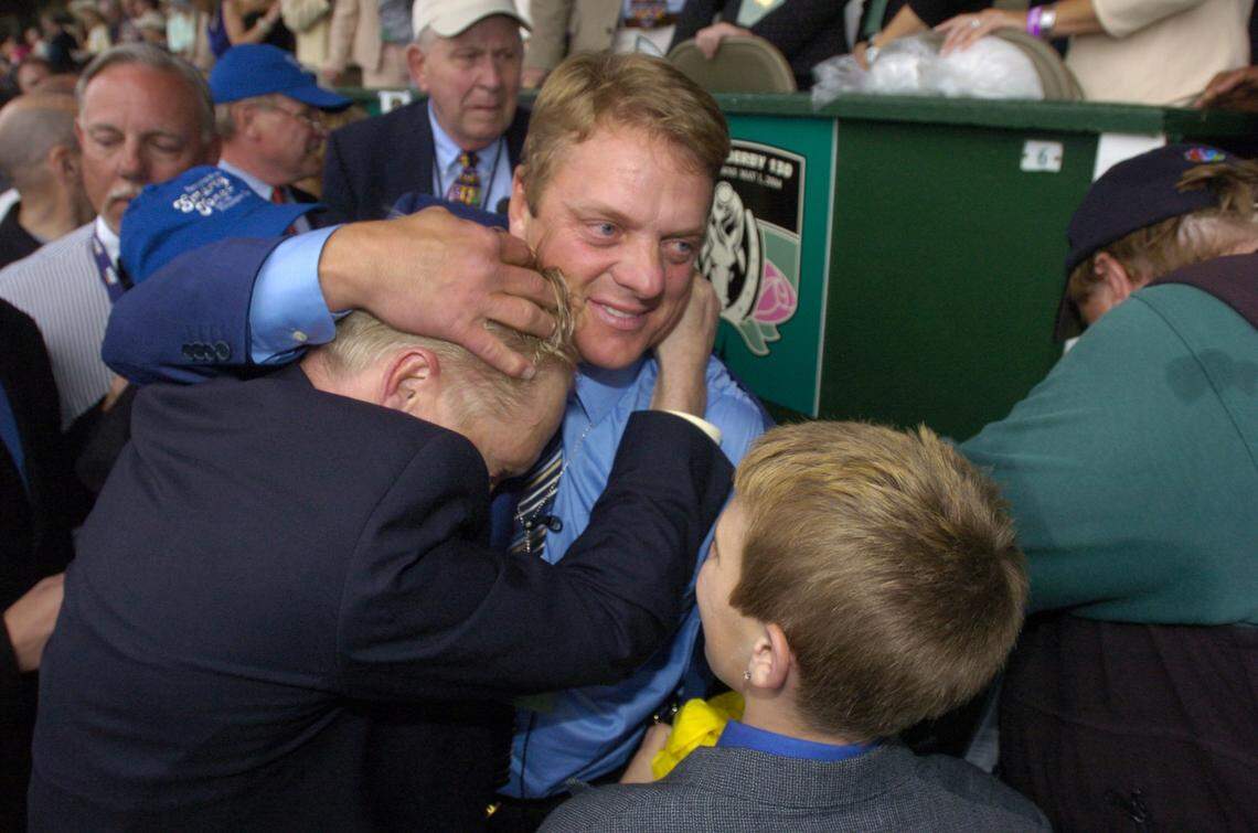 John Servis (center) hugged his brother Jason after winning the 2004 Kentucky Derby with Smarty Jones.