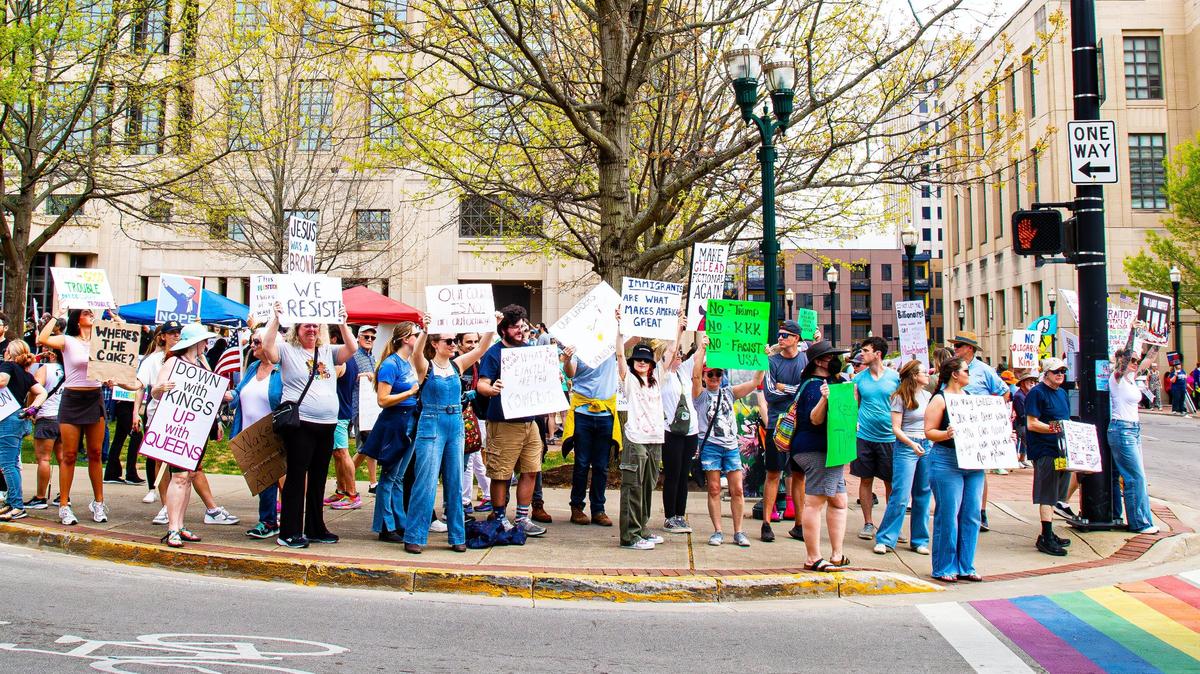 Protesters stand on the corner of Limestone with signs as cars pass by and honk in support of their efforts during the “No Kings Then, No Kings Now” Peaceful March and Protest in front of the Robert F. Stephens Courthouse, downtown Lexington, Ky, April 19, 2025.