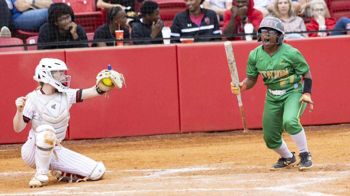 Bryan Station’s Aniyah Farris celebrates her bases-loaded walk in the fifth inning of the Defenders’ 9-4 win in the 42nd District Softball Tournament championship game at Scott County High School on Wednesday in Georgetown.