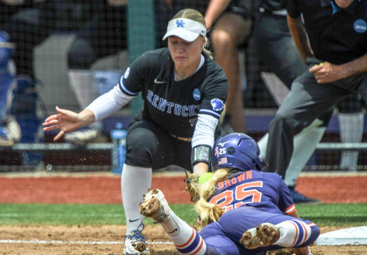 Clemson senior Alex Brown (25) safely slides under the tag of Kentucky sophomore Ally Hutchins (7) at third base during the top of the fourth inning of the NCAA Softball Clemson Regional at McWhorter Stadium in Clemson Sunday, May 18, 2025.