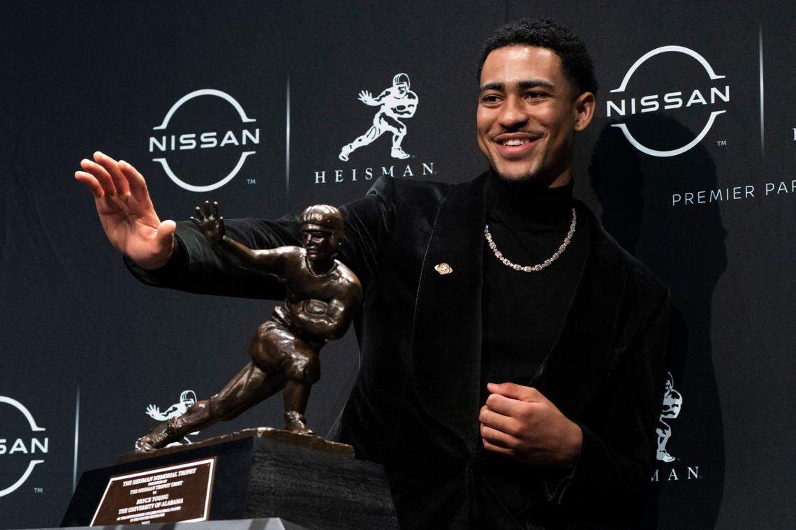 Alabama quarterback Bryce Young poses for a photograph after winning the 2021 Heisman Trophy.