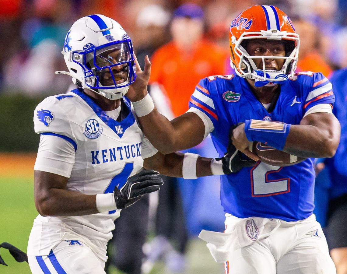 Florida Gators quarterback DJ Lagway (2) stiff arms Kentucky Wildcats defensive back Kristian Story (4) during the first half at Ben Hill Griffin Stadium in Gainesville, FL on Saturday, October 19, 2024 against the Kentucky Wildcats. [Doug Engle/Gainesville Sun]