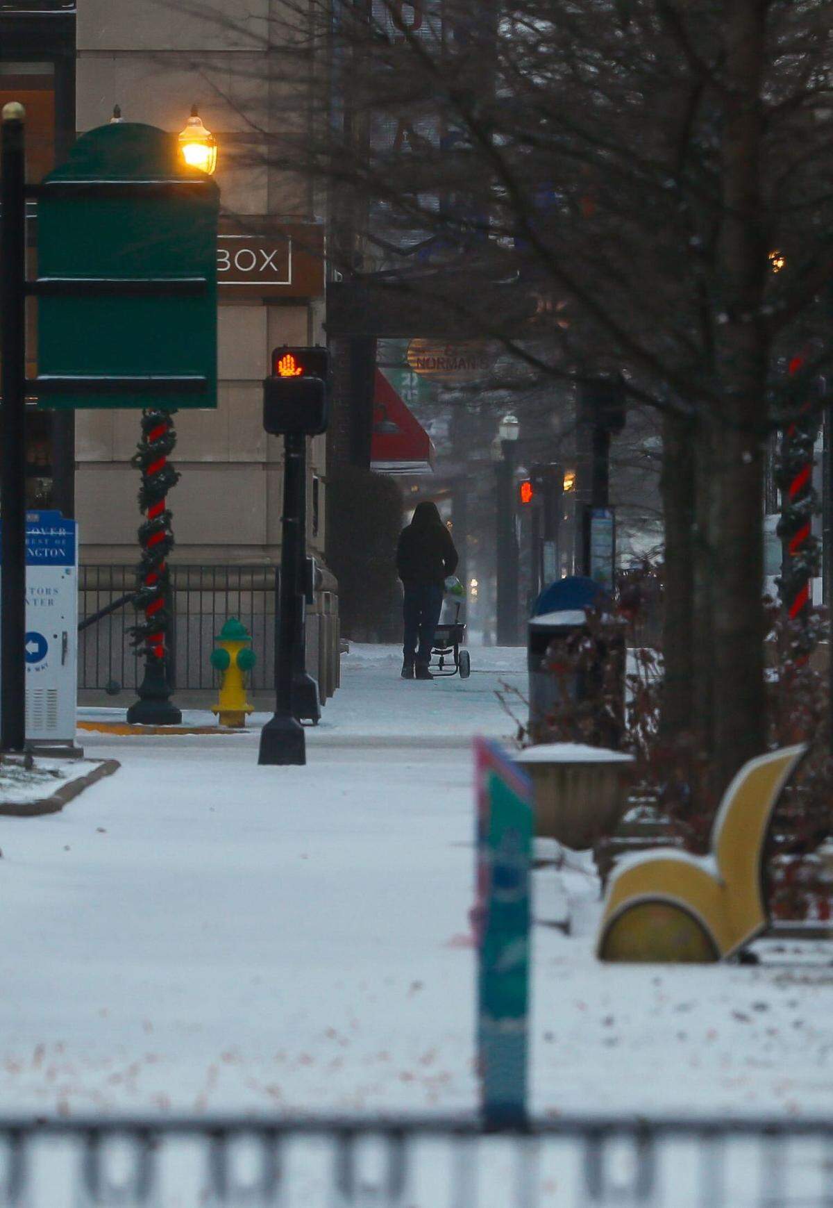 Snow covers sidewalks in Lexington as Kentucky deals with freezing temperatures and precipitation on Friday, Dec. 23, 2022.