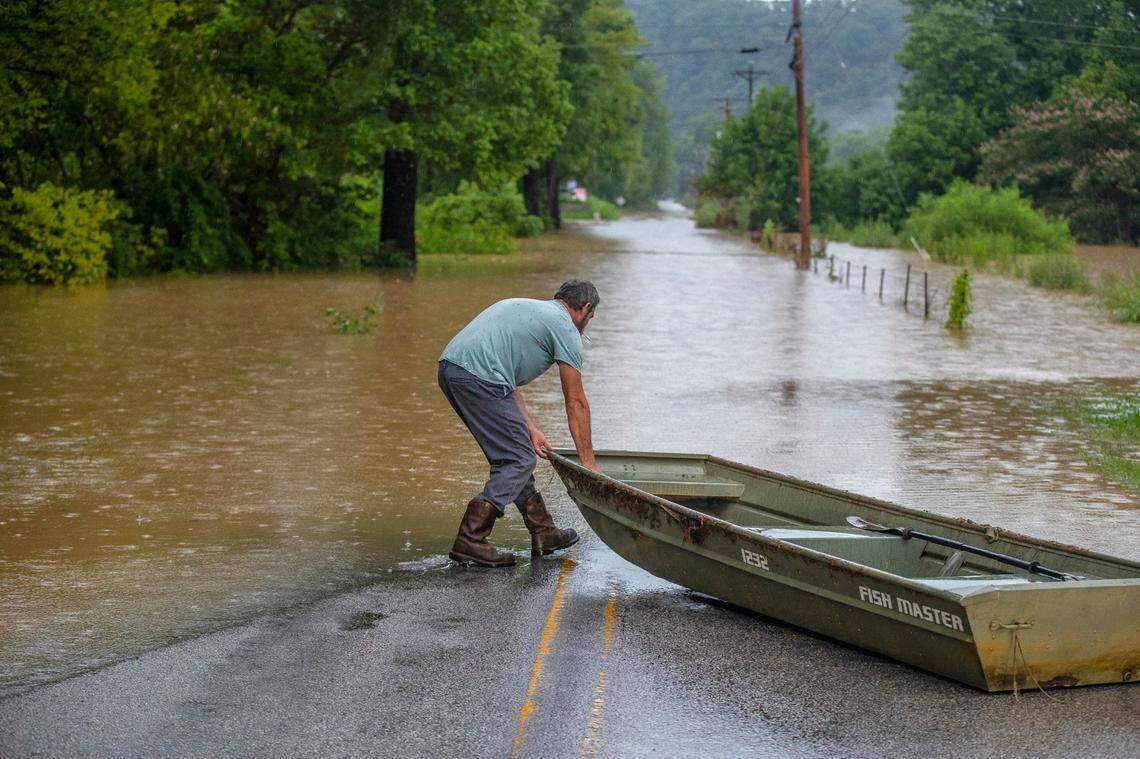 A man prepares to launch a boat near flooded Wolverine Road in Breathitt County, Ky., on Thursday, July 28, 2022. Heavy rains have caused flash flooding and mudslides as storms pound parts of central Appalachia. Kentucky Gov. Andy Beshear says it’s some of the worst flooding in state history.