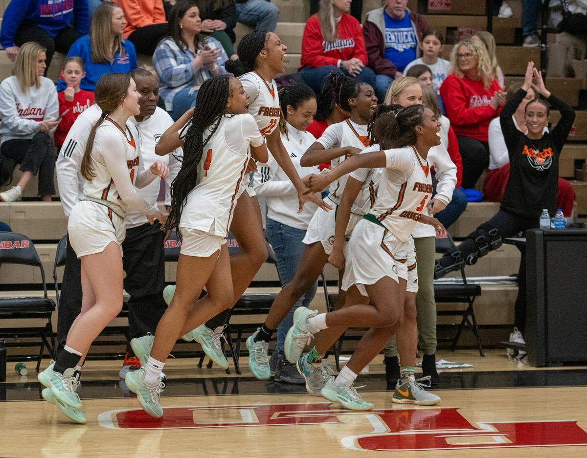 Kate Baker, right, celebrates her teams’ victory in the 11th Region Tournament championshp game on Saturday night. The Frederick Douglass senior is out for the season after suffering a torn ACL on Feb. 18.