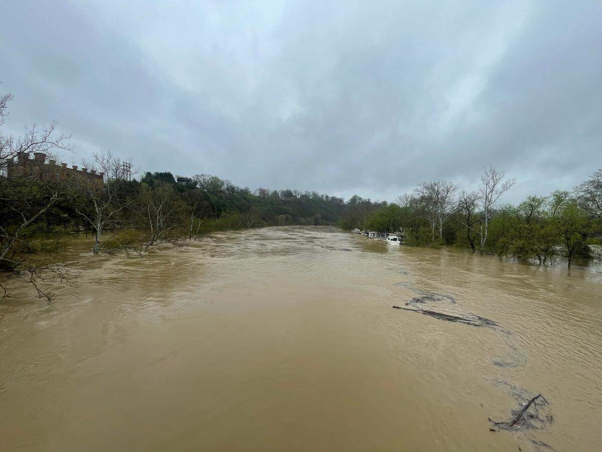 People strolled the War Mother’s Memorial Bridge to take photos and video of the historic flooding in the Kentucky River.