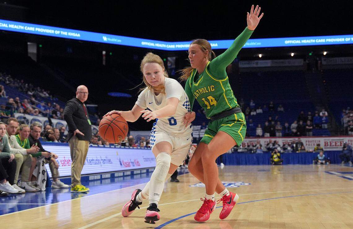 Simon Kenton’s Brynli Pernell drives against Owensboro Catholic’s Layla Martin during the Clark’s Pump-N-Shop Girls’ Basketball Sweet 16 quarterfinals at Rupp Arena on Friday.