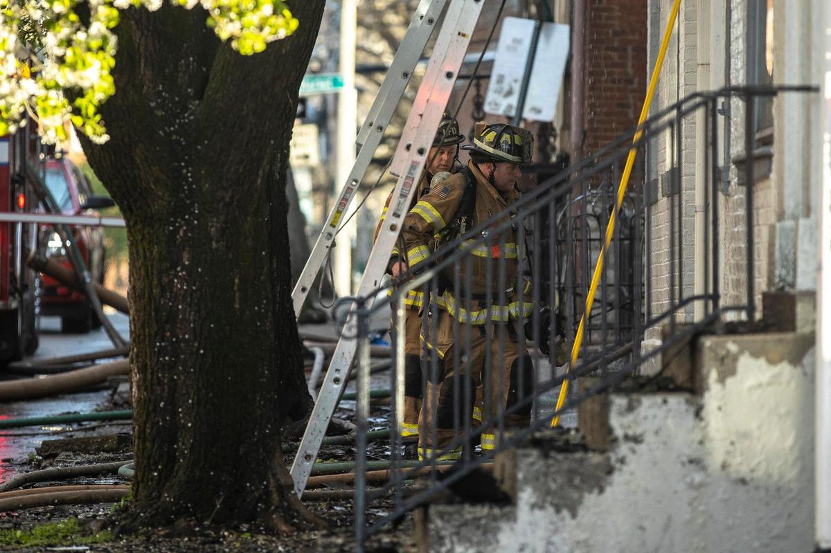 Members of the Lexington Fire Department respond to a structure fire at the corner of North Upper and West Second streets in downtown Lexington, Ky., on Thursday, March 31, 2022.